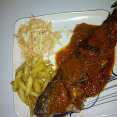 A picture of Grilled fish,irish potatoes with coslaw.