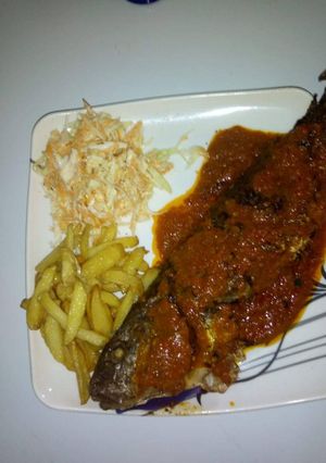 A picture of Grilled fish,irish potatoes with coslaw.
