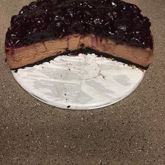 A picture of Gregtsters Chocolate Cheesecake with Black-cherry Glaze & Oreo cookie infused with coffee crust!!!!!.
