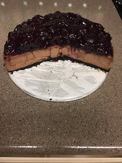 A picture of Gregtsters Chocolate Cheesecake with Black-cherry Glaze & Oreo cookie infused with coffee crust!!!!!.