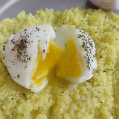 A picture of Dalia made with ghee and half boiled egg.