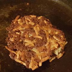 A picture of Burger and hashbrown cakes.