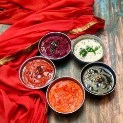 A picture of Five varieties of chutney.