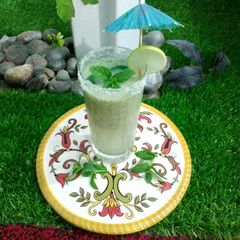 A picture of Raw mango with a coconut drink.
