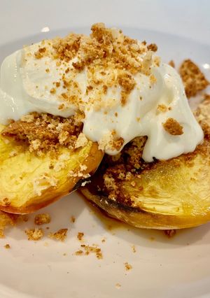A picture of Baked Peaches with honey, amaretti and creme fraiche.