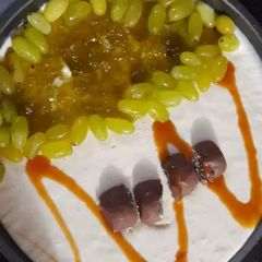 A picture of 3 layered Cadbury and kiwi grapes Cheese cake 2 in 1.