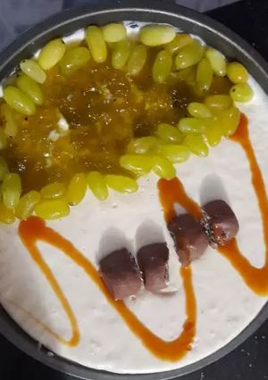 A picture of 3 layered Cadbury and kiwi grapes Cheese cake 2 in 1.