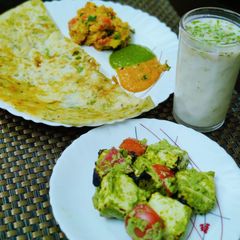 A picture of Sooji chilla with mint paneer and Lassi.