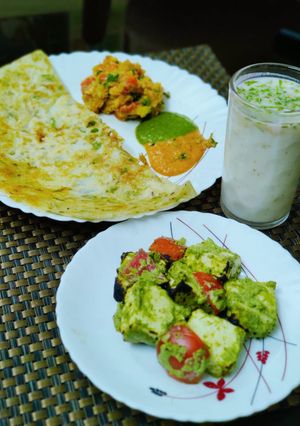 A picture of Sooji chilla with mint paneer and Lassi.