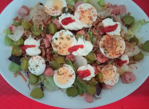 Una foto de Ensalada con huevo duro, Frankfurts y pepinillos