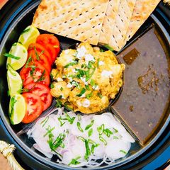 A picture of Malai Boti with sheermaal and chutney.