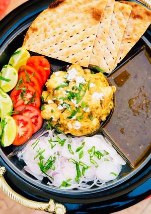 A picture of Malai Boti with sheermaal and chutney.