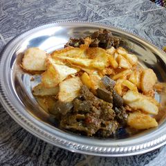 A picture of Golden yam and offals sauce.