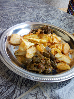 A picture of Golden yam and offals sauce.