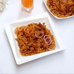 A picture of Palm oil jollof rice with dry fish.