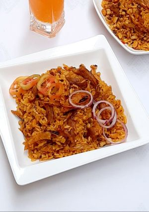 A picture of Palm oil jollof rice with dry fish.