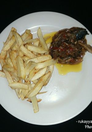 A picture of French fries &fish sauce.