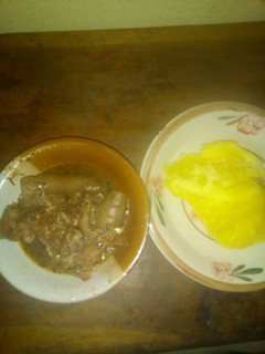 A picture of Okro soup with pomo and yellow garri.