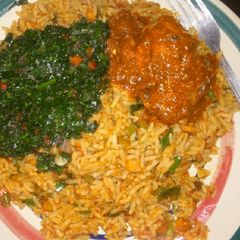 A picture of Simple Jollof and half cooked pumpkin leaf!.