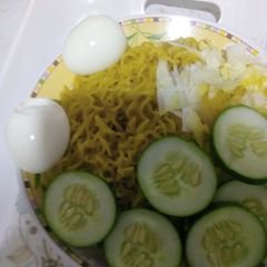 A picture of Indomie with vegetables and egg.