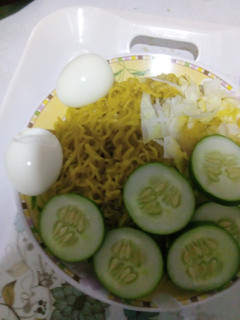A picture of Indomie with vegetables and egg.