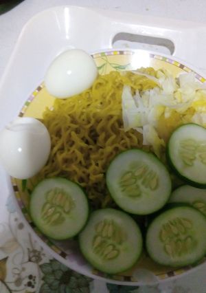 A picture of Indomie with vegetables and egg.