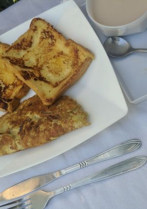 A picture of French toast, omelette and tea.