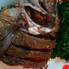 A picture of Deep fried fish with sukuma wiki.