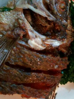 A picture of Deep fried fish with sukuma wiki.