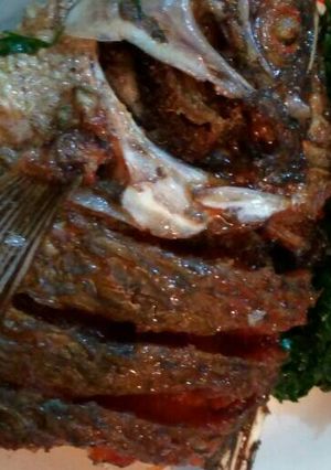 A picture of Deep fried fish with sukuma wiki.