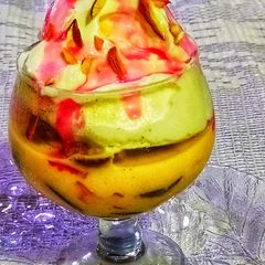 A picture of Fruit custard with Dry fruit Vanilla ice cream.
