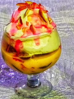 A picture of Fruit custard with Dry fruit Vanilla ice cream.