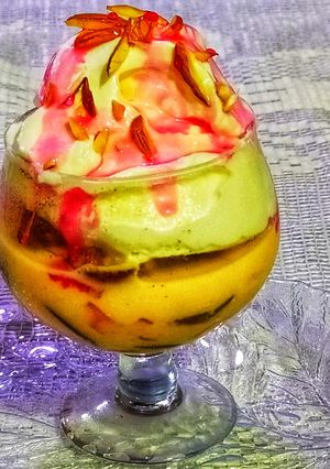 A picture of Fruit custard with Dry fruit Vanilla ice cream.