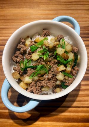 A picture of Easy Beef and Potato Bowl with Green Onion, Toasted Sesame Seeds, and Spicy Chili Crisp.