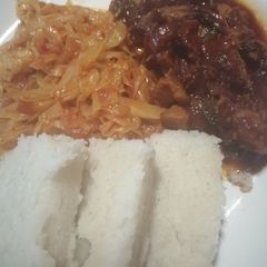 A picture of Ugali, cabbage and wet fry beef.