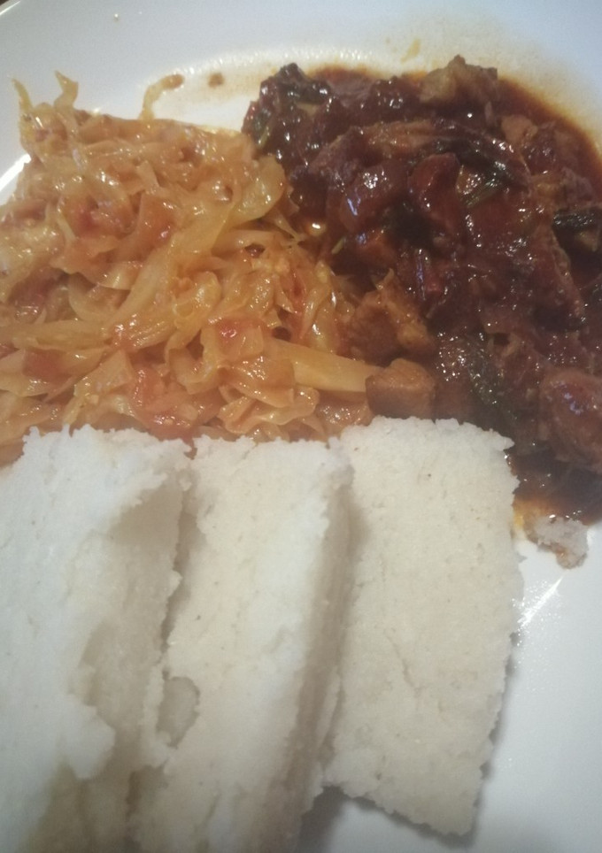 A picture of Ugali, cabbage and wet fry beef.
