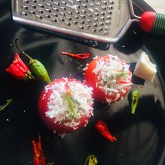 A picture of Pesto chesse baked Tomatoes.