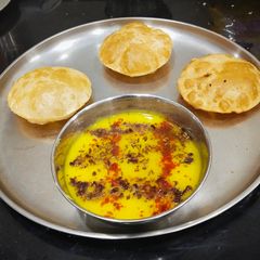 A picture of Yellow Moong Daal With Puri.