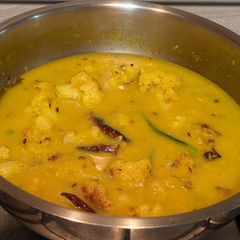 A picture of Moong Dal with peas and cauliflower.