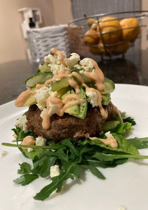 A picture of Cheat meal: bacon and mushroom burger patties.