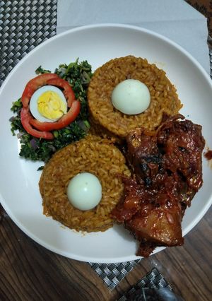 A picture of Bright light Jellof & P.P Chiken -fish with Sunrise Spinach.