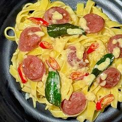 A picture of Creamy Salted Egg Tagliatelle with Taiwanese Chicken Sausage.