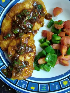 A picture of Chicken Steaks with red sauce.