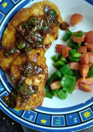 A picture of Chicken Steaks with red sauce.