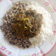 A picture of Shredded meat souce with rice/beans.