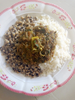 A picture of Shredded meat souce with rice/beans.