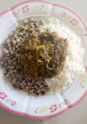 A picture of Shredded meat souce with rice/beans.