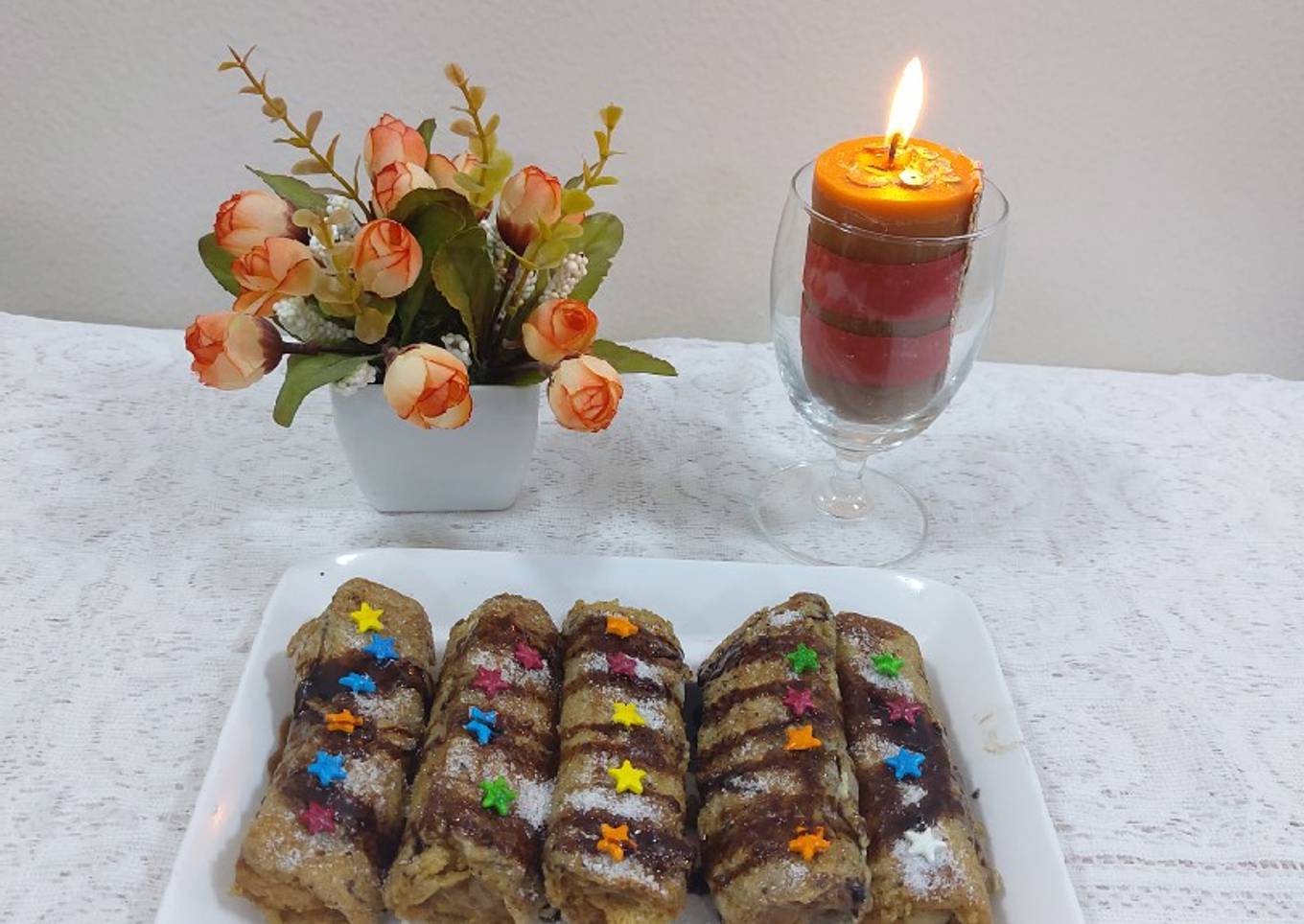 Banana cinnamon bread rolls with chocolate syrup garnish