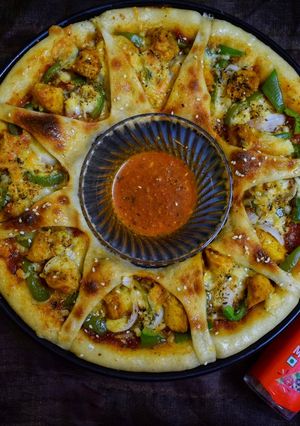A picture of Chicken tikka ring pizza.