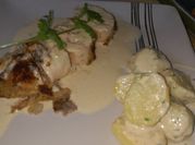 Una foto de pechuga de pollo relleno en salsa blanca